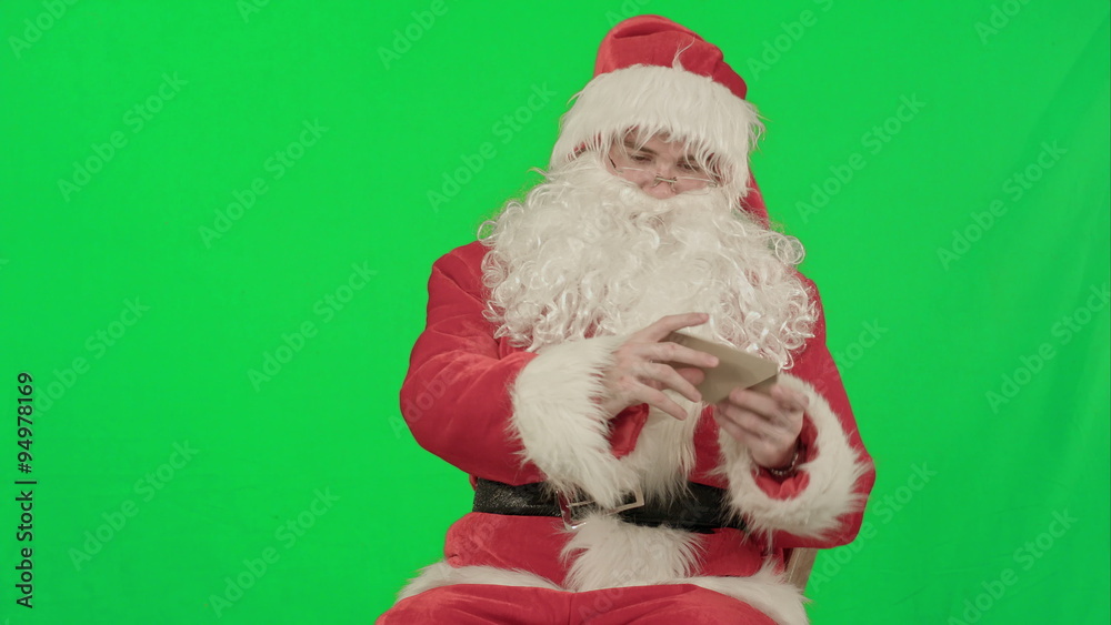 Santa with Christmas letter or wish list on a Green Screen Chrome Key Santa with Christmas letter or wish list on a Green Screen Chrome Key