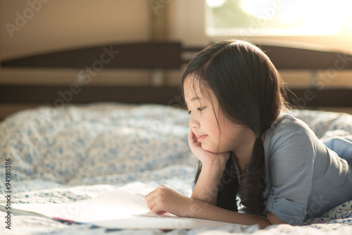 Happy asian girl reading