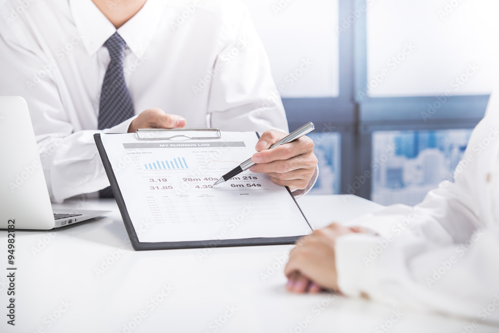 Business people discussing the charts and graphs showing the res Business people discussing the charts and graphs showing the res