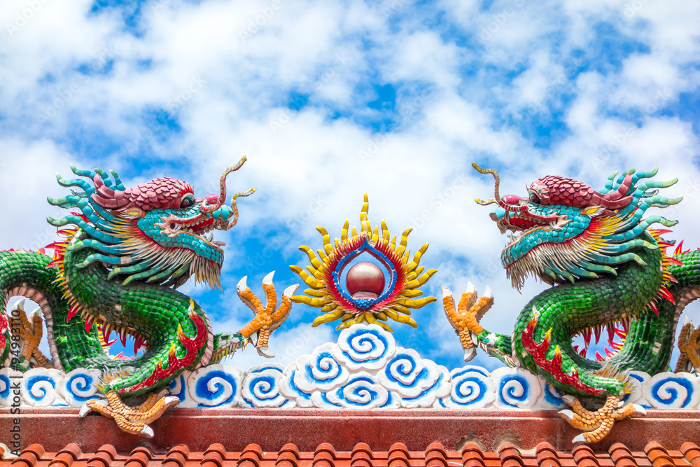 Two dragon on red roof with cloudy blue sky, Chinese temple in T