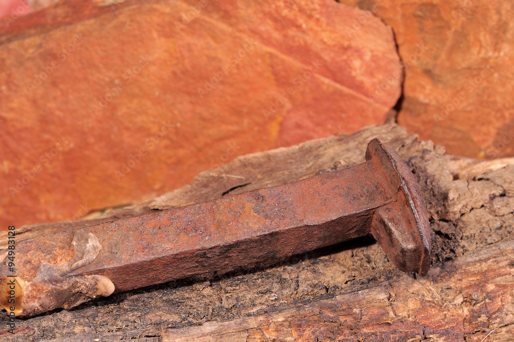 Rusted nail of the original Ghan railway line on a piece of rotten timber near Alice Springs, Australia 2015 Rusted nail of the original Ghan railway line on a piece of rotten timber near Alice Springs, Australia 2015