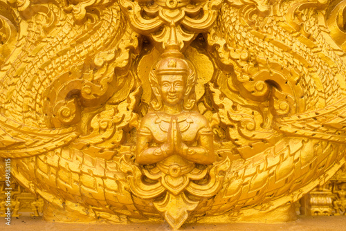 Gold Angel Buddha statue on the Wat wall thailand