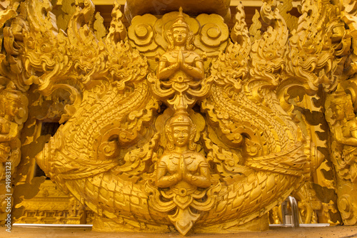 Gold Angel Buddha statue on the Wat wall thailand © apirutsiri