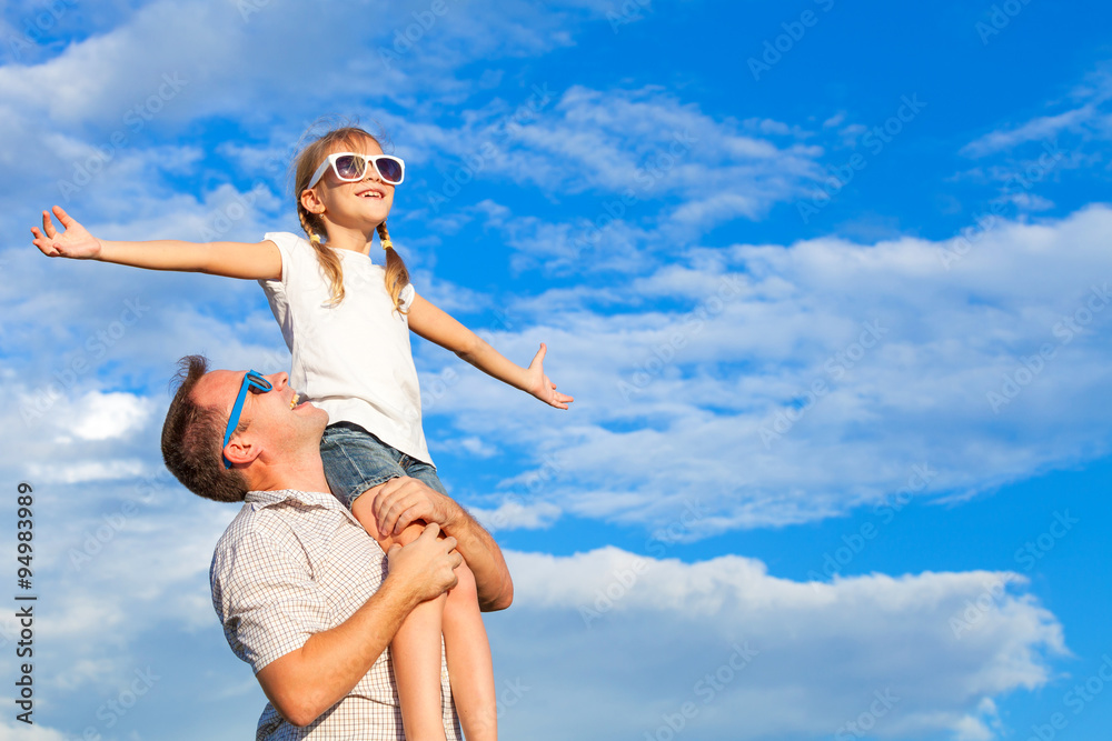 Father and daughter playing in the park at the day time. Father and daughter playing in the park at the day time.