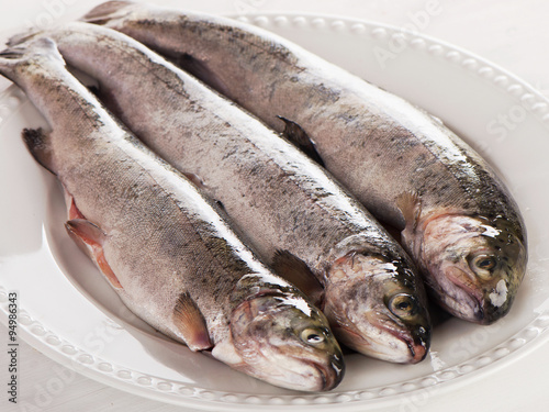 Rainbow trouts on a white plate. photo