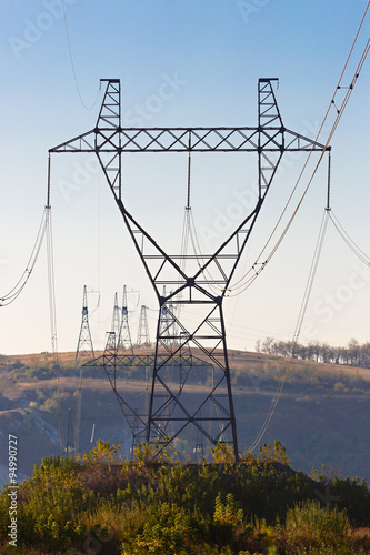 Columns high voltage power photographed in daylight.