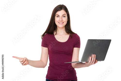 Brunette woman use of laptop computer and finger point aside