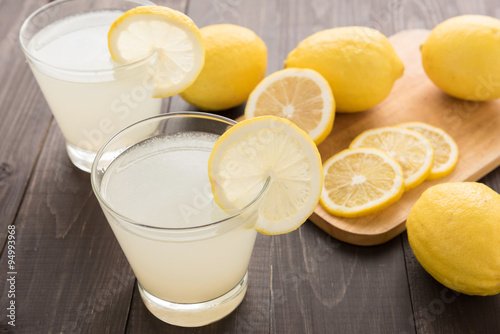 lemonade with fresh slice lemon on wooden table