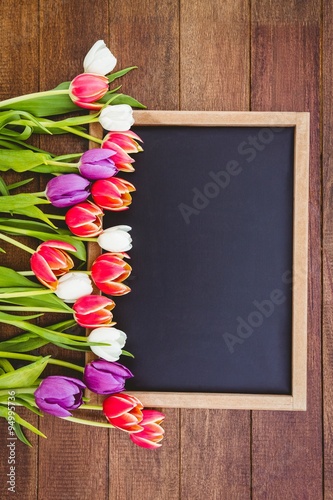 Fototapeta Naklejka Na Ścianę i Meble -  Bouquet of colored flowers against black board