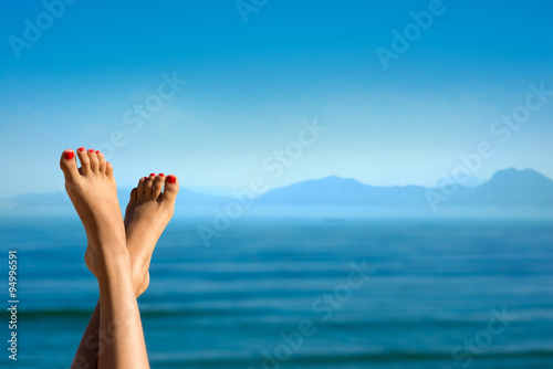 Feet of girl on the background of mountains. 