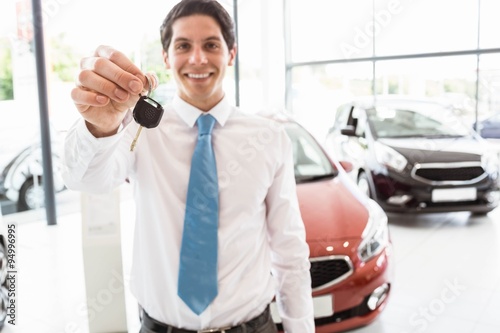  Salesman standing while offering car keys © WavebreakMediaMicro