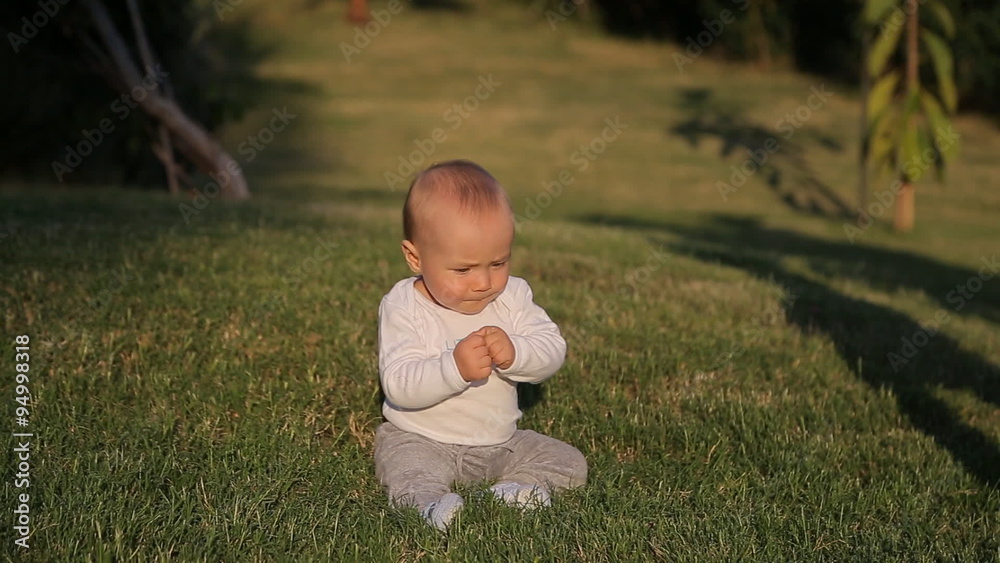 Little boy sitting on the grass Little boy sitting on the grass