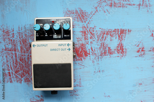 Guitar pedal on grunge background  photo