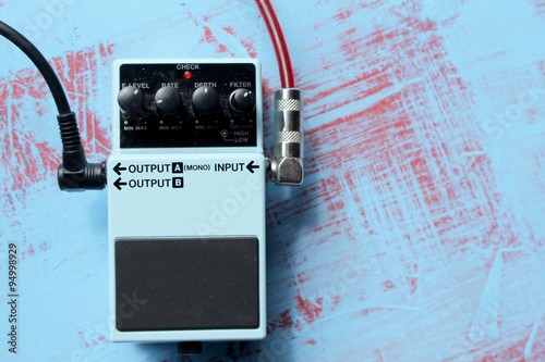 Guitar pedal on grunge background 