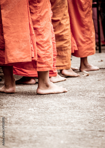 Barefoot of Buddhist monk while stand in a row 