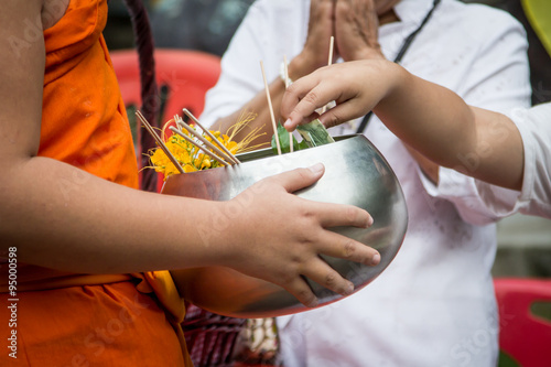 People give alms food and item offering to Buddhist monk