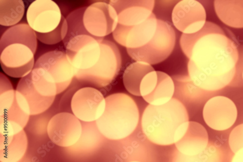 Gold Bokeh Christmas Background. Festive lights dark golden colo