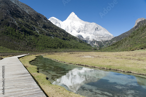 Tibet snow mountain with river photo
