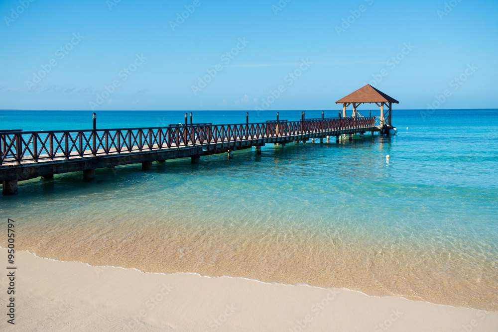 Long wooden jetty for ships, stretching into the sea