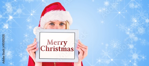 Composite image of festive blonde holding a tablet pc © vectorfusionart