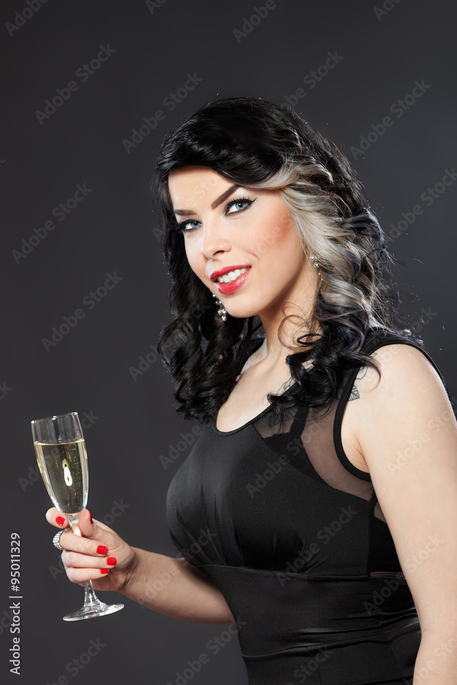 Beautiful young woman celebrating with a glass of champagne