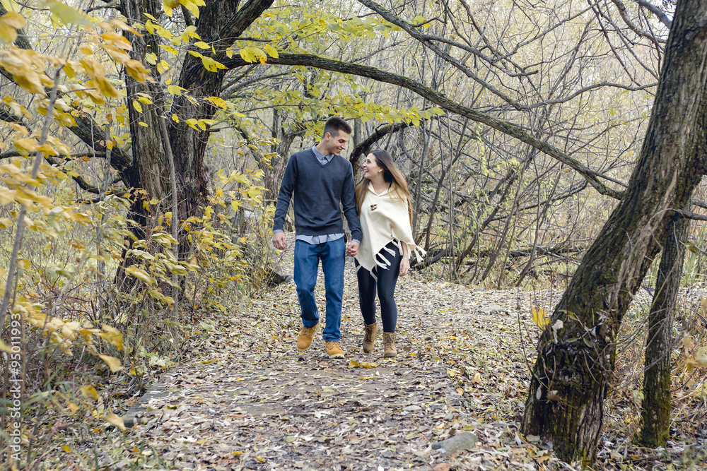 Teen couple at autumn park