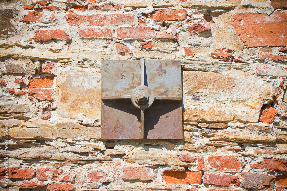 Old brick wall reinforced with metal plates Old brick wall reinforced with metal plates
