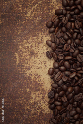 Dark roasted coffee beans on shabby chic surface © iLight photo