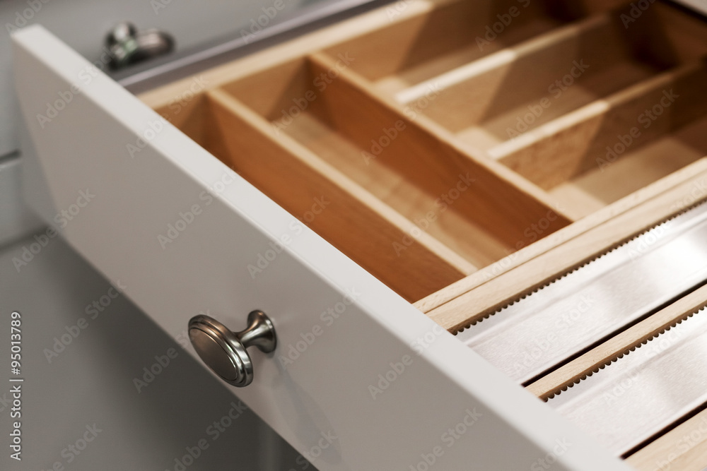 Closeup of open wooden drawer for cutlery