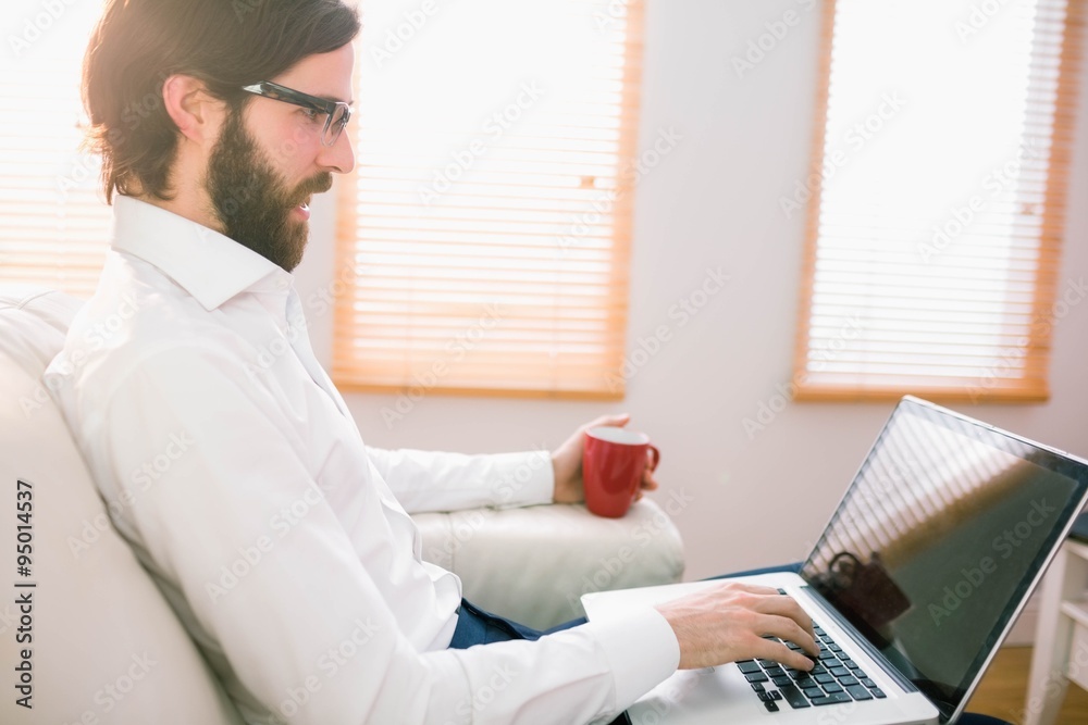 Businessman using laptop on the couch Businessman using laptop on the couch