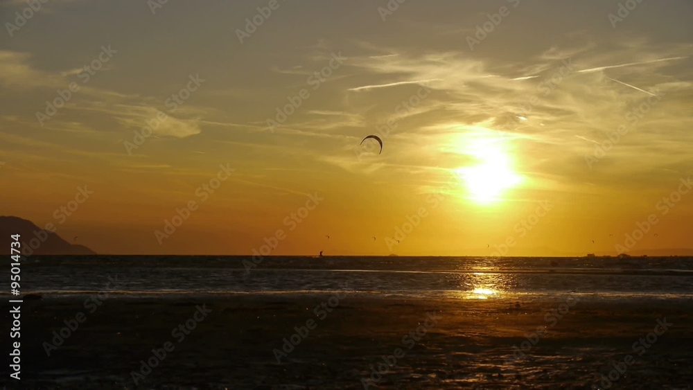 Kiteboarder jumping at sunset Kiteboarder jumping at sunset