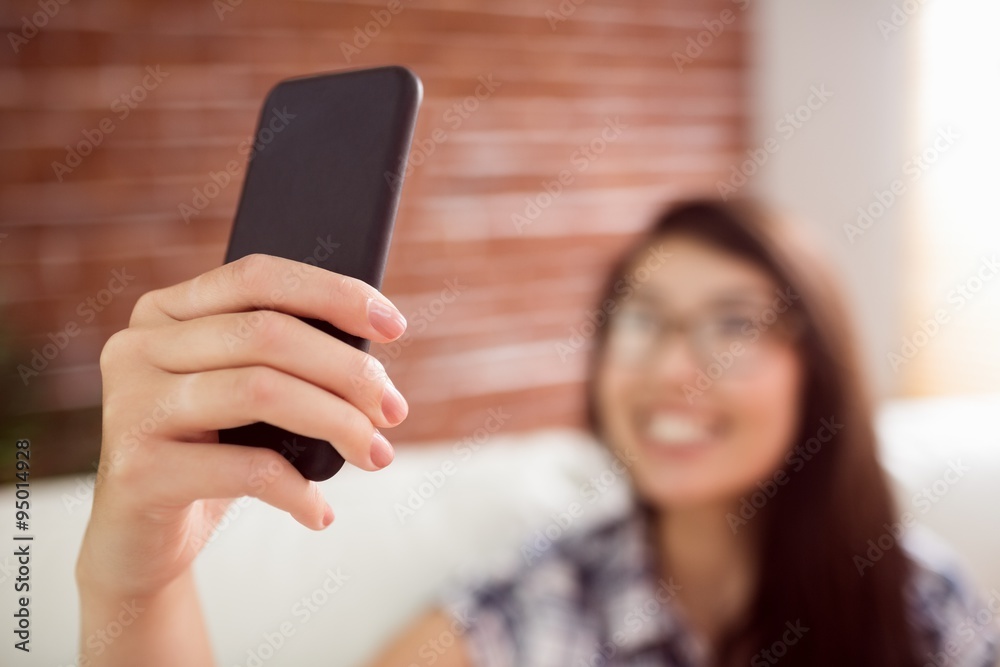 Asian woman on the couch taking selfie Asian woman on the couch taking selfie