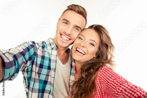 Happy pretty couple in love making selfie