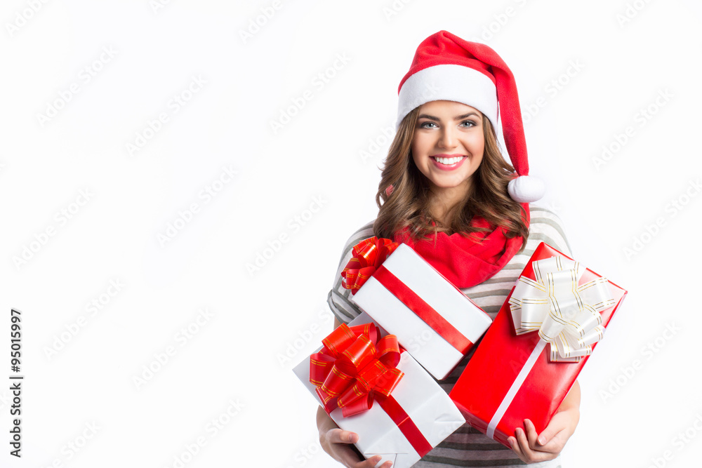 Cute girl holding a Christmas and New Year gifts. Christmas girl in santa hat with boxes. Cute girl holding a Christmas and New Year gifts. Christmas girl in santa hat with boxes.