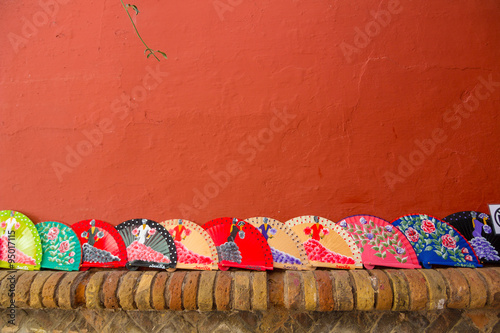 Canvas Print Fans Andalusian of colors on a red background