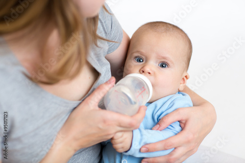 Little girl baby drinking from bottle