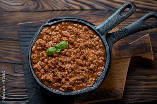 Bolognese sauce in a frying pan, above view, studio shot