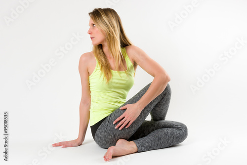 Blond woman doing yoga and stretching exercises
