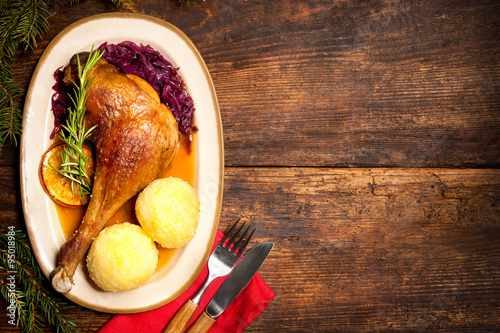 Crusty goose leg with braised red cabbage and dumplings photo