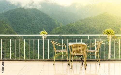 Table and chair. Spring design with alpine forest and empty disp photo