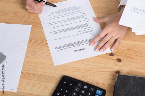 woman thinking about signing a contract