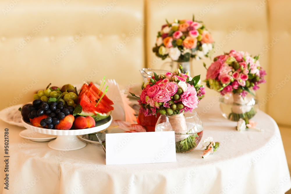 Fruit stil vase with flowers white tablecloth Fruit stil vase with flowers white tablecloth