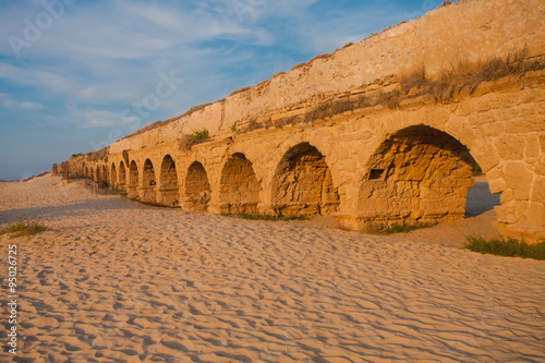 Ancient Roman aqueduct at sunset photo