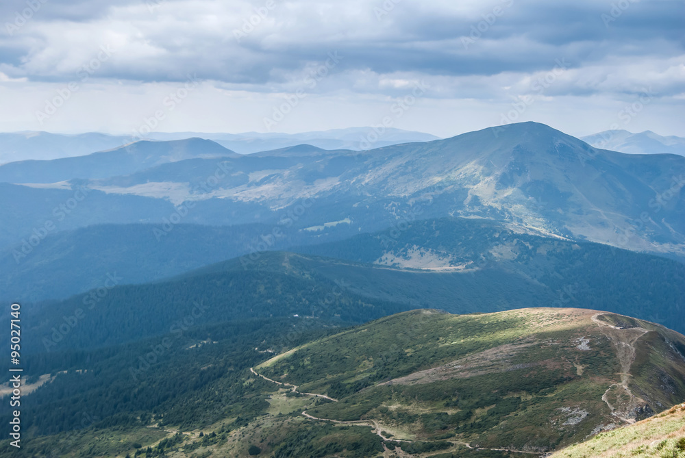 Fototapeta premium View of misty mountains in summer Carpathians, Ukraine