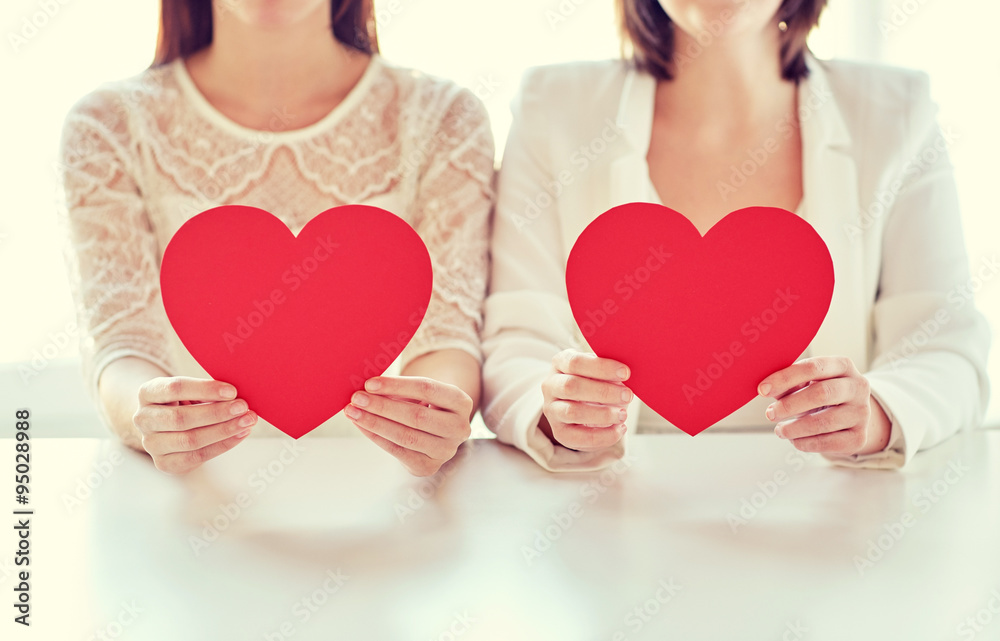 close up of happy lesbian couple with red hearts close up of happy lesbian couple with red hearts