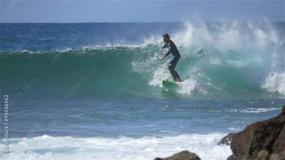 SLOW MOTION: Young surfer riding a big wave SLOW MOTION: Young surfer riding a big wave