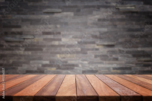 Empty top wooden table and stone wall background © SKT Studio