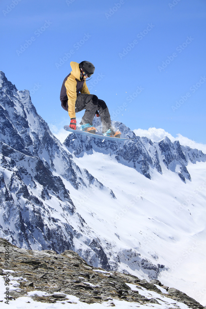 Flying snowboarder on mountains