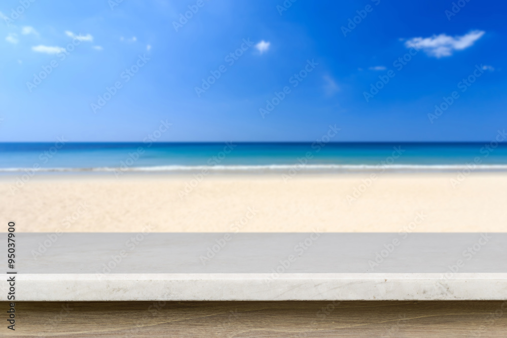 Empty top of natural stone table and view of tropical beach back Empty top of natural stone table and view of tropical beach back