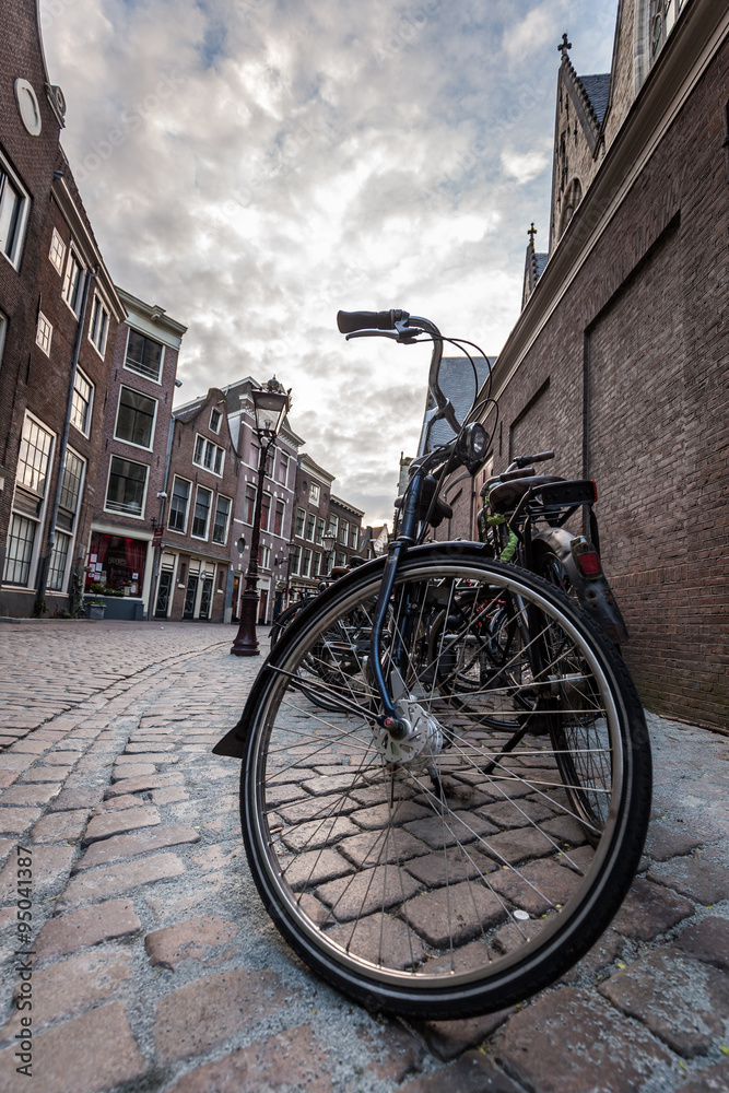 Fototapeta premium Red light district, Amsterdam, Netherlands. Vintage bikes parked on the street.